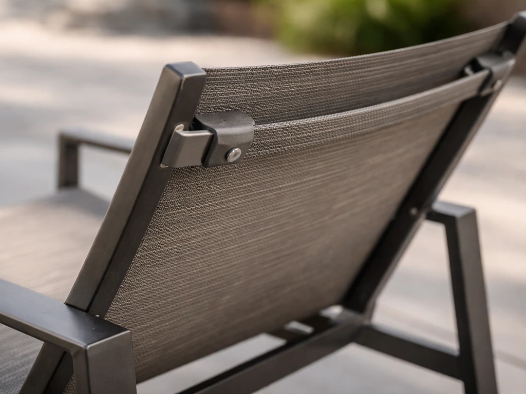 Close-up of an outdoor sling chair showing woven fabric tension and frame connection points
