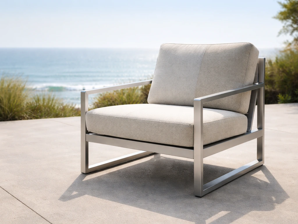 Sunny coastal patio with an aluminum lounge chair, showing intact finish and subtle sun-fade on the cushion.