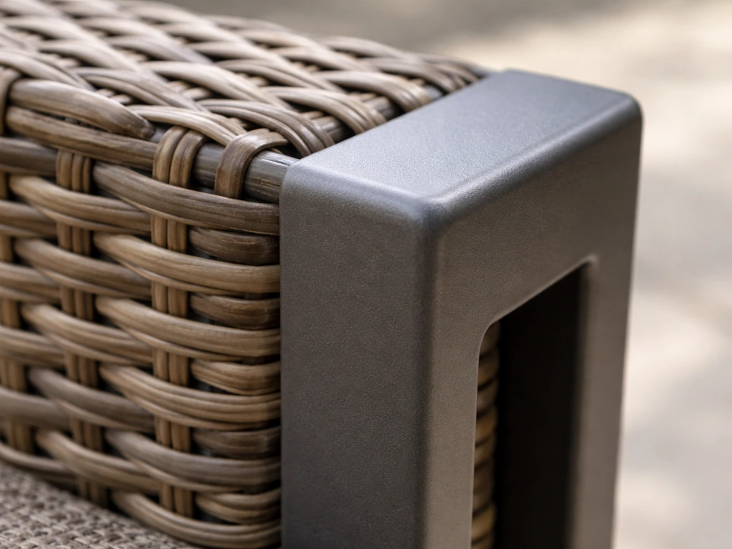Close-up of powder-coated aluminum frame and PE resin wicker weave texture in a minimal setting.