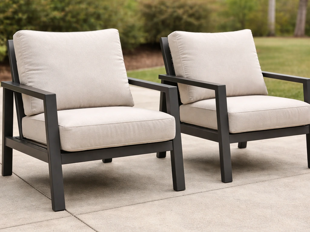 Two patio chairs side by side showing thick cushions, supportive back angle, and weather-ready frames.