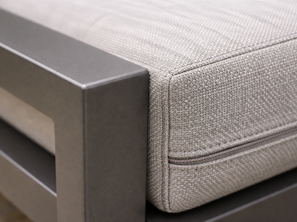 Macro close-up of powder-coated aluminum frame corner, cushion stitching, and zipper details.